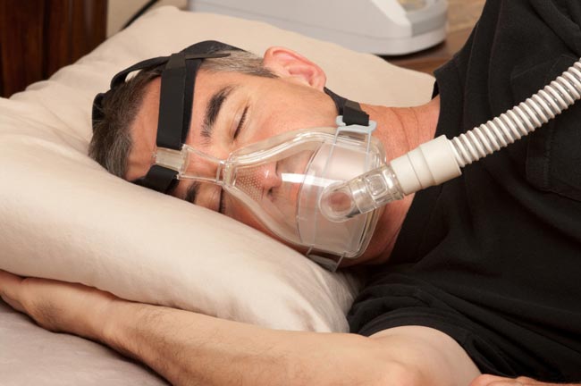 Mask with sleep apnea hooked up to a Cpap machine while sleeping