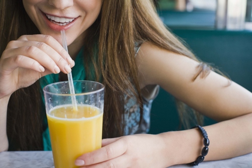 Woman drinking from straw