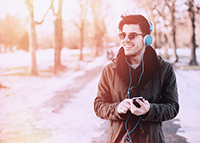 guy listening to music and taking a winter walk