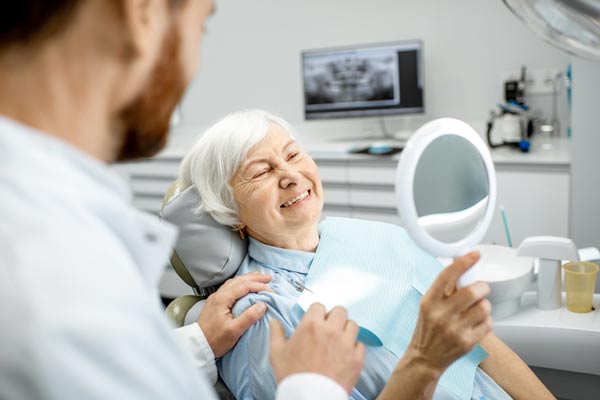 Elderly woman enjoying her new smile at Singing River Dentistry in Tuscumbia AL 35674-2413 