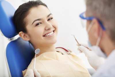 Smiling person getting a dental exam