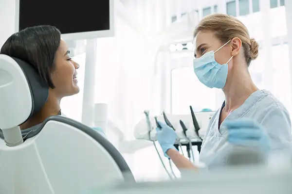 Dental hygienist consulting with a patient during a routine checkup, focusing on preventive dentistry and oral health.